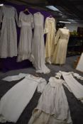 Eight vintage ladies wedding / occasion dresses, including 1950s with peplum detail to waist.