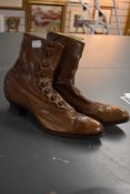 A pair of tan leather Edwardian boots with button fastening and stack heel.