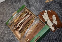 A box full of vintage unused gents driving gloves, around twenty five pairs.