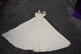 A 1940s cream taffeta gown having unusual straps, fabric concealed side metal zip and beading to