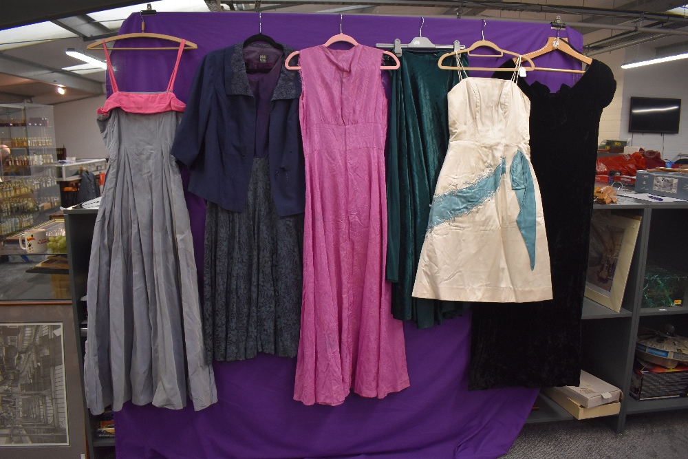 A variety of 1950s and 60s dresses and gowns, mixed styles, some with labels such as Harvey