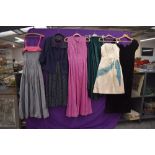 A variety of 1950s and 60s dresses and gowns, mixed styles, some with labels such as Harvey