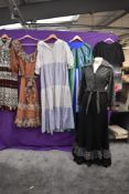 A collection of ladies 1970s dresses including maxi dresses and glittery skirt and blouse set.