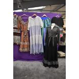 A collection of ladies 1970s dresses including maxi dresses and glittery skirt and blouse set.