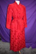 A full length Chinese dressing gown or house coat in cherry red silk or silk blend fabric, frog