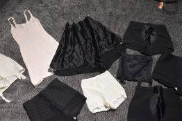 A collection of vintage girdles, a pair of 1940s black tap pants of knickers and similar, also