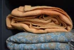 A vintage blue and beige fringed bed throw and pure new wool Witney blanket in caramel.