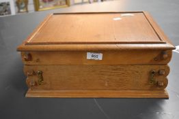 An impressive large wooden sewing box containing a selection of haberdashery, buttons, embroidery