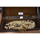 A selection of costume jewellery in wooden case including simulated pearls