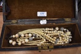 A selection of costume jewellery in wooden case including simulated pearls