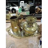 A metal framed hallway mirror a brass oil lamp and a water jug