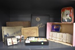 A box of Cigarette Cards in albums and loose including Wills, Players, Senior Service etc