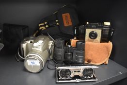 A selection of cameras and binoculars including Olympus and Brownie 127