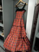 A vintage 1950s tartan evening gown with tiered skirt and matching bolero.