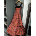 A vintage 1950s tartan evening gown with tiered skirt and matching bolero.