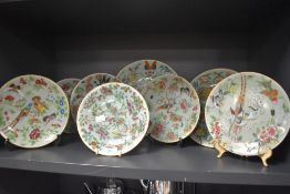 A collection of eight hard paste Chinese plates in Cantonese designs painted with butterfly bird and