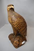 A hand carved wooden sculpture of an American style eagle