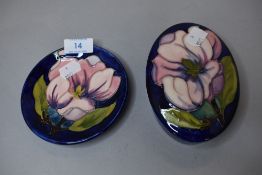 Two pieces of Moorcroft pottery a lidded case and matching pin dish in deep blue hues