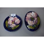 Two pieces of Moorcroft pottery a lidded case and matching pin dish in deep blue hues