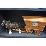 A vintage ceramic horse pulling wooden Romany caravan.