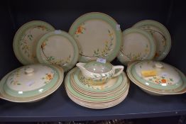 A part dinner service by Clarice Cliff having a hand decorated design on cream ground