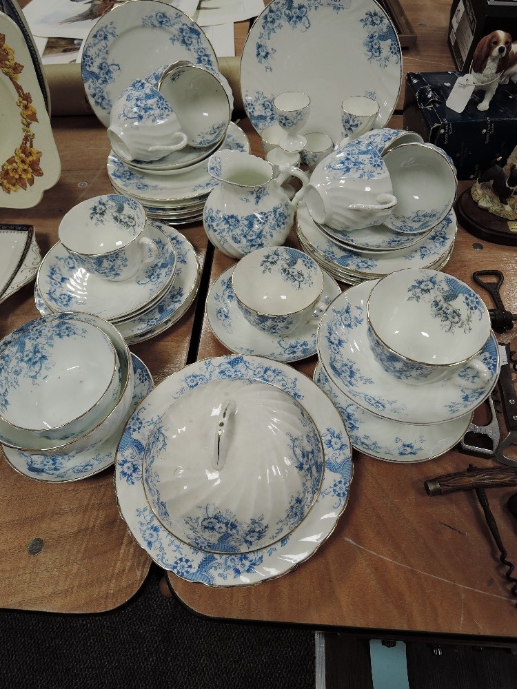 A part tea service in porcelain having blue transfer print and swirl design