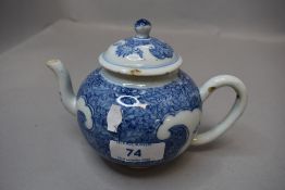 A small antique Chinese hard paste porcelain tea pot hand decorated with traditional blue and