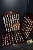 A selection of collectable ceramic and similar thimbles in fitted display cases