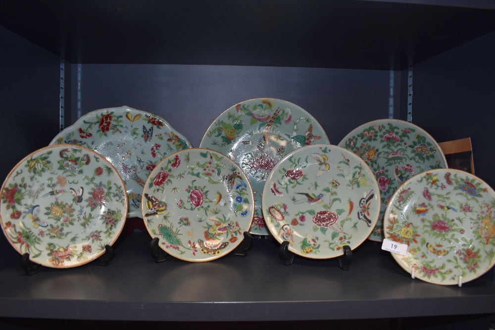 A collection of seven hard paste Chinese plates in Cantonese designs painted with butterfly bird and