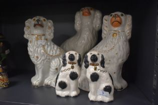 A selection of antique flat back Staffordshire dogs including pair of small spaniel dogs