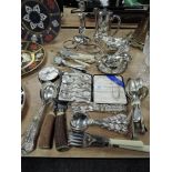A selection of plated table wares and loose cutlery including gravy boats and serving spoons