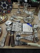 A selection of plated table wares and loose cutlery including gravy boats and serving spoons