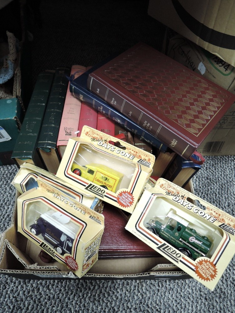 A selection of library books and die cast model cars