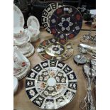 Two ceramic display plates by Royal Crown Derby in imari designs and a similar pair of Caverswall