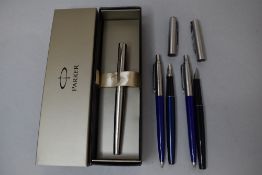 A boxed Parker stainless steel fountain pen and two modern Parker fountain pens, a Parker mechanical
