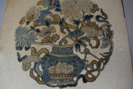 An antique needlework embroidery of a floral vase