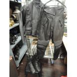 A Bellstaff motor cycle jacket and a pair of similar leather pants and boots