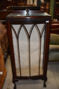 A 1920's mahogany narrow display cabinet having blind fret Greek key decoration, and claw and ball