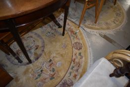 Two Chinese circular rugs, pair pattern wise but differently sized