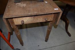 A Victorian stripped drop leaf kitchen table