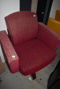 A vintage armchair on swivel base, semi recliner, on metal swivel base in moquette upholstery