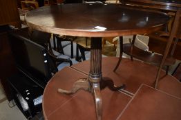 A 19th century mahogany pedestal table having circular top on fluted column and triple splay legs, w