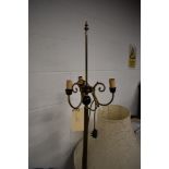 A vintage brass three branch standard lamp