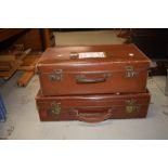 A vintage leather suitcase and a similar period composite suitcase