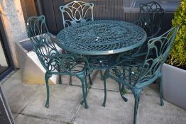 A modern metal garden table and four chairs