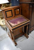 An early 20th century mahogany and ebony, French style Davenport, having cupboard super structure