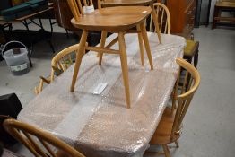 A light Ercol dining table and six dining chairs (4 plus 2 different but complimentary designs)