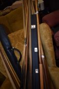 A selection of snooker cues, various