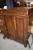 An early 20th century part walnut French cabinet, having frieze drawer with cupboard under,