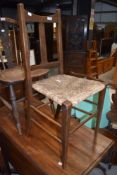 A Victorian oak and rush seated kitchen chair